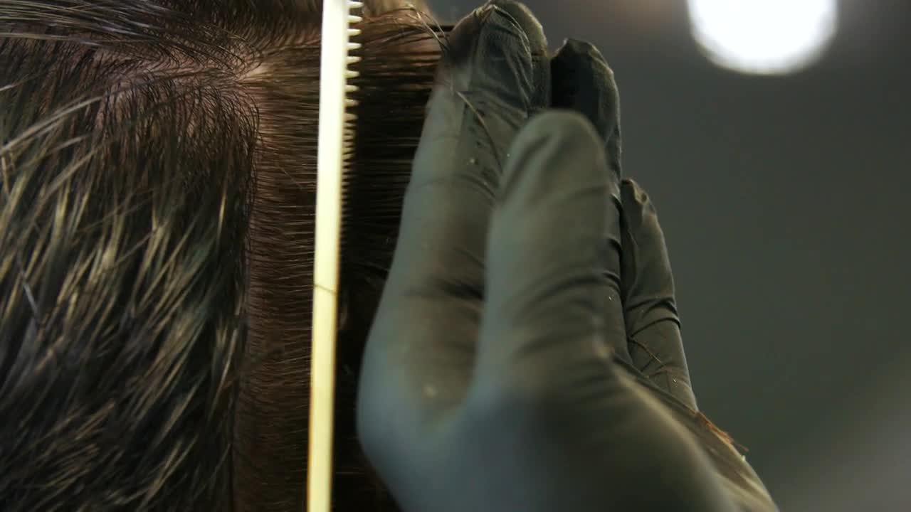 Stock Video Hands Of A Stylist Taking A Lock Of Hair Animated Wallpaper