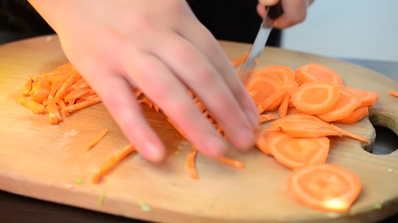 Stock Video Hands Of A Person Chopping Carrots On A Board Animated Wallpaper