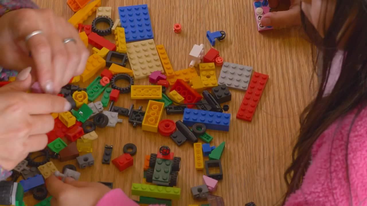 Stock Video Hands Of A Mother And Daughter Playing With Legos Animated Wallpaper