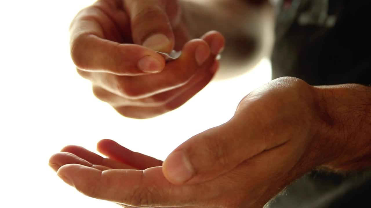Stock Video Hands Of A Man Taking Pills From A Packaging Animated Wallpaper