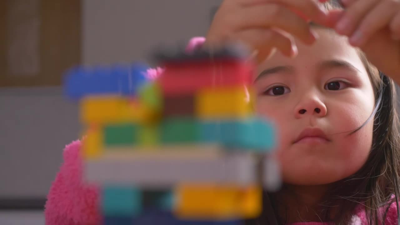 Stock Video Hands Of A Girl Putting Together A Figure With Legos Animated Wallpaper