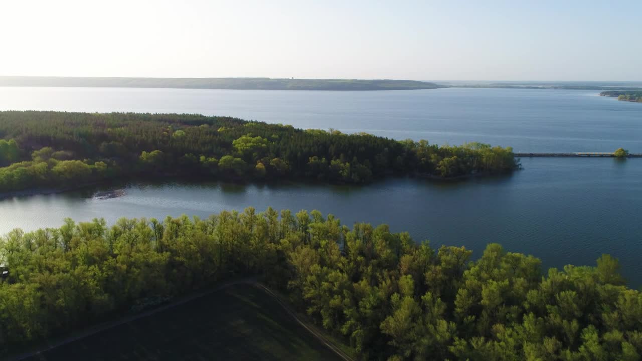 Stock Video Landscape Of Trees Next To A Blue River Animated Wallpaper