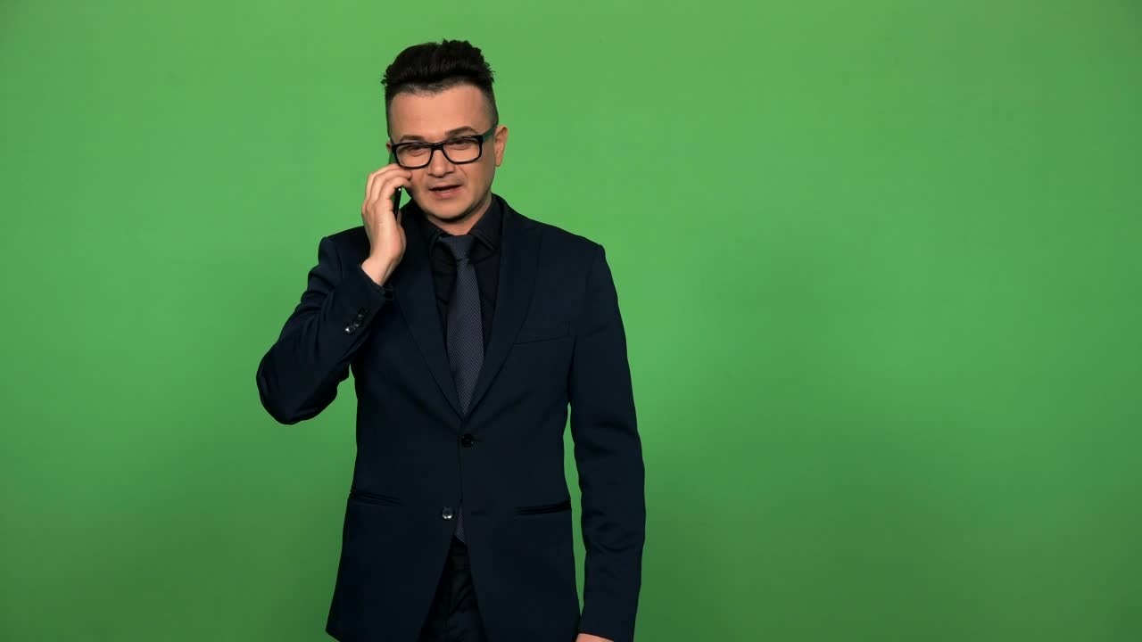 Stock Video Man In Suit And Glasses Answering A Phone Call Animated Wallpaper