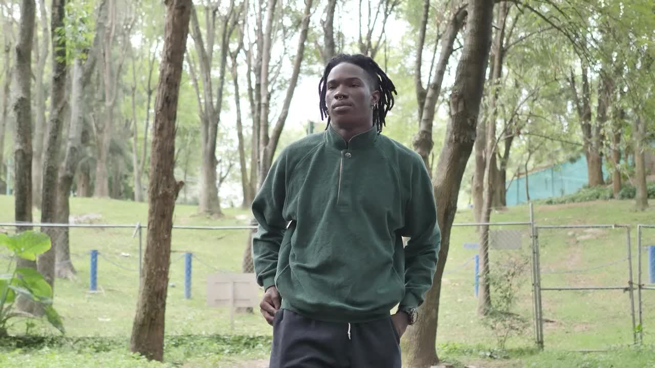 Stock Video Man In Sportswear Walking Through A Park Animated Wallpaper