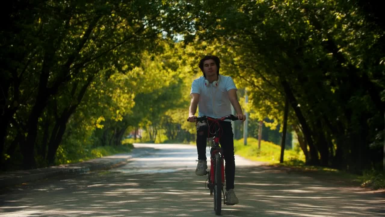 Stock Video Man In Riding A Bike Stops To Put On His Animated Wallpaper