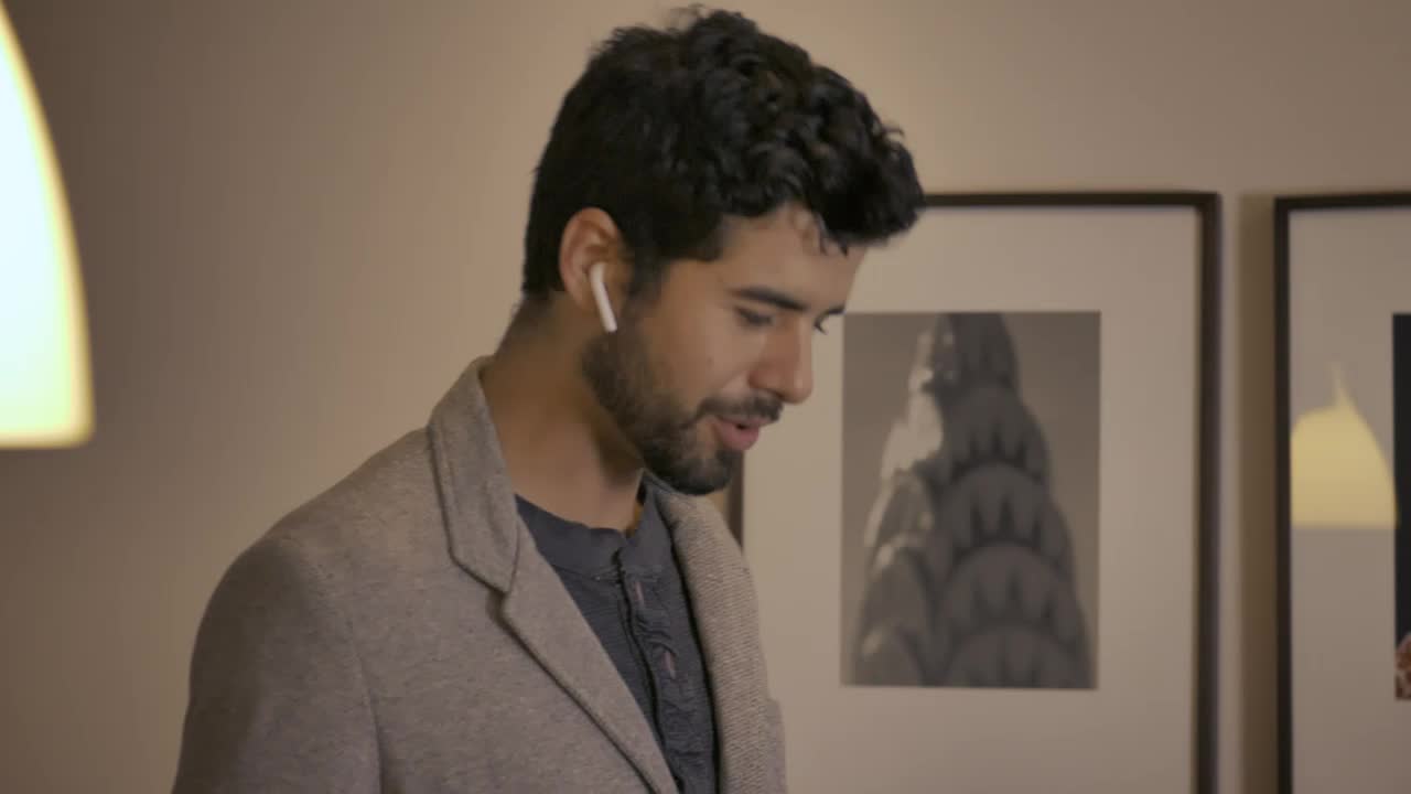 Stock Video Man In His Apartment During A Phone Call Animated Wallpaper