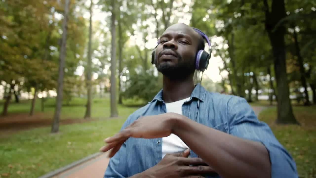Stock Video Man In Headphones Dances Hiphop In Park Animated Wallpaper