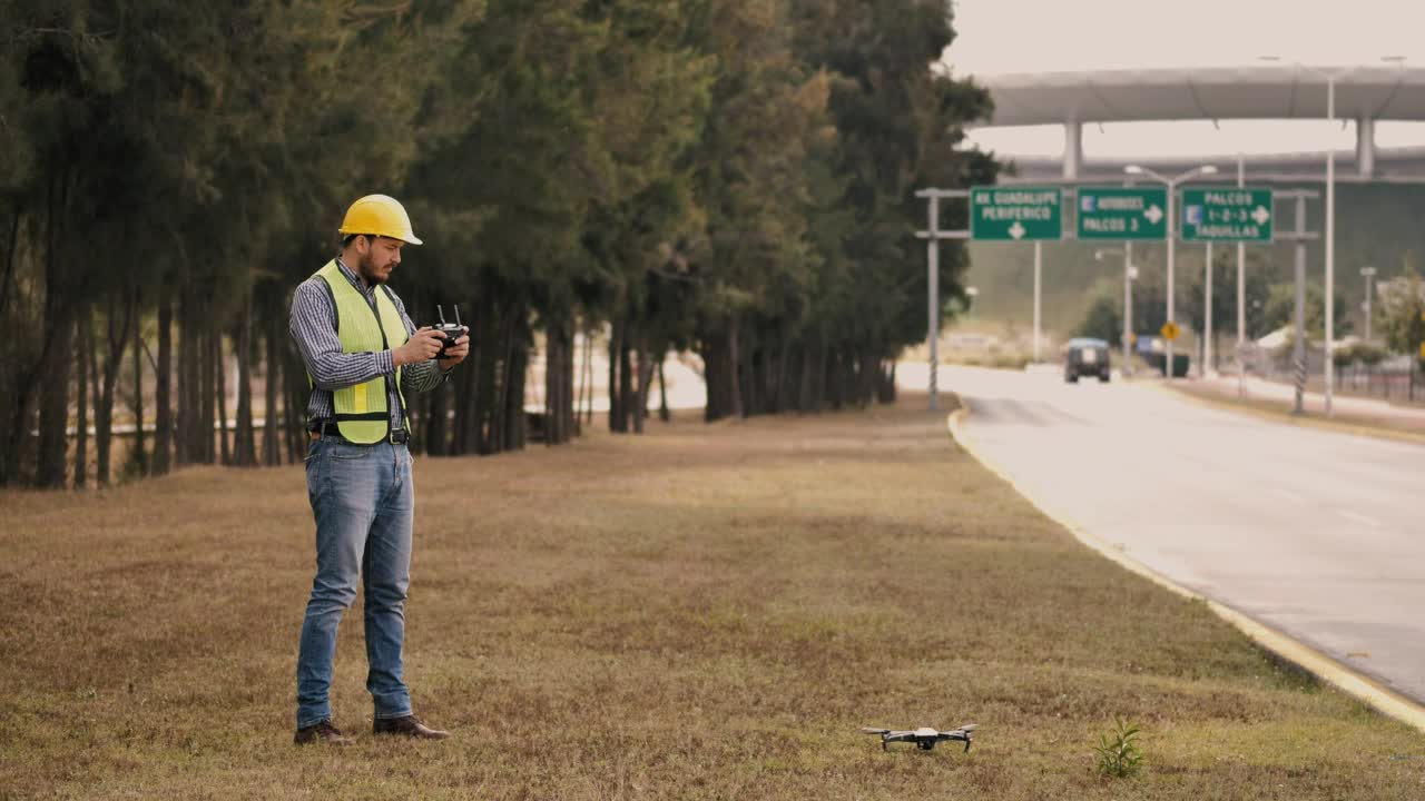 Stock Video Man In Hard Hat Flying Drone On Side Of The Animated Wallpaper