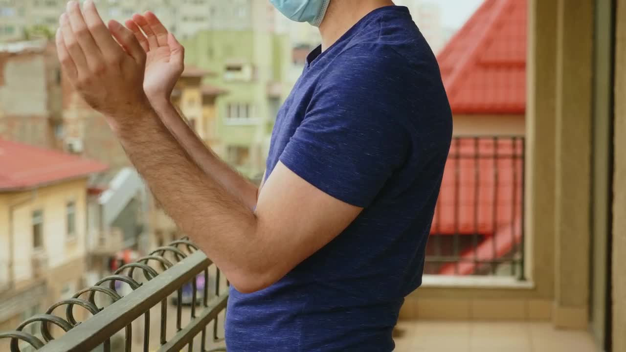 Stock Video Man In Covid Quarantine Applauds From Balcony Animated Wallpaper