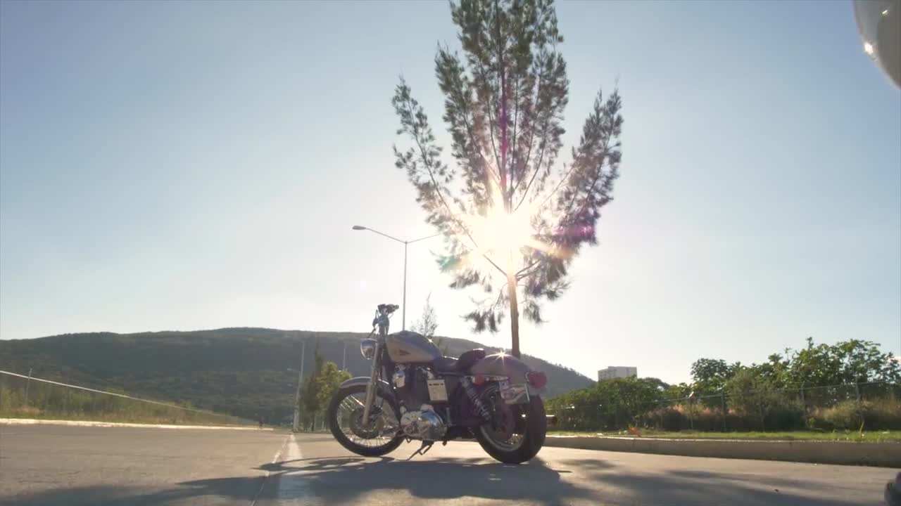 Stock Video Man In Biker Gear Approaches Stationary Motorcycle Animated Wallpaper