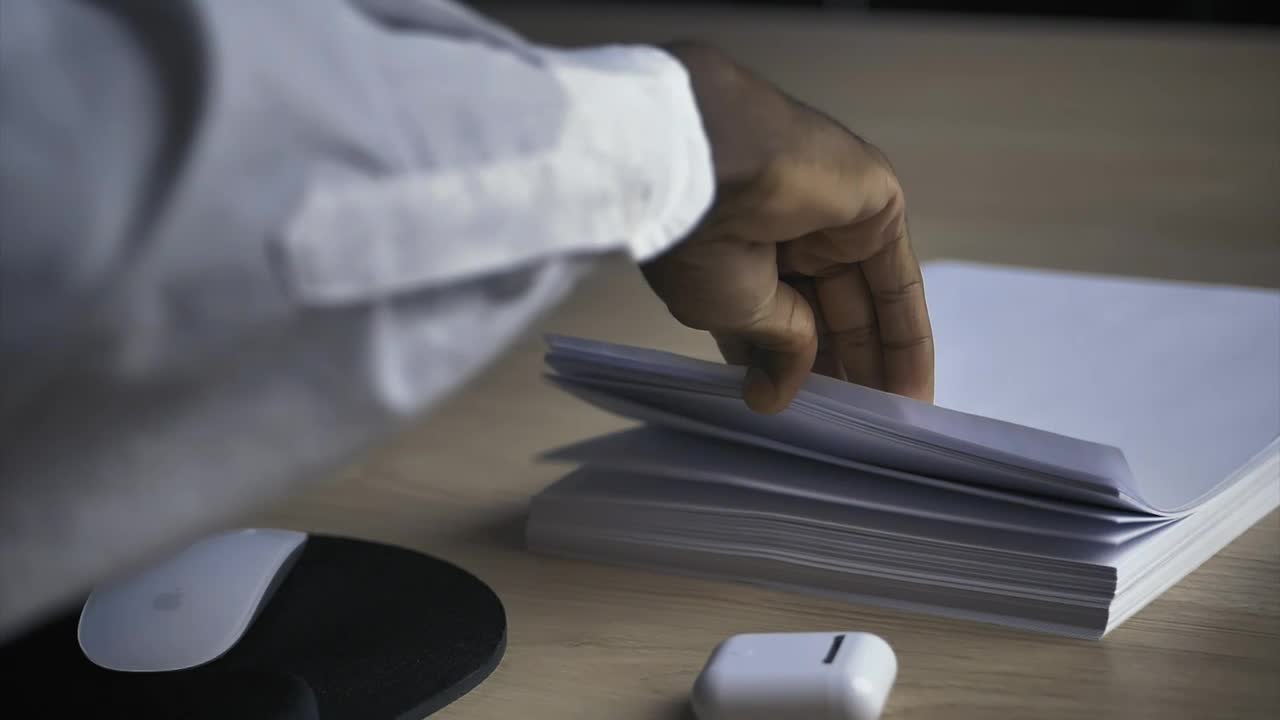 Stock Video Man In An Office Taking A White Sheet Of Paper Animated Wallpaper