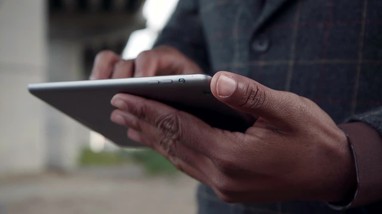 Stock Video Man In A Suit Using A Tablet Animated Wallpaper