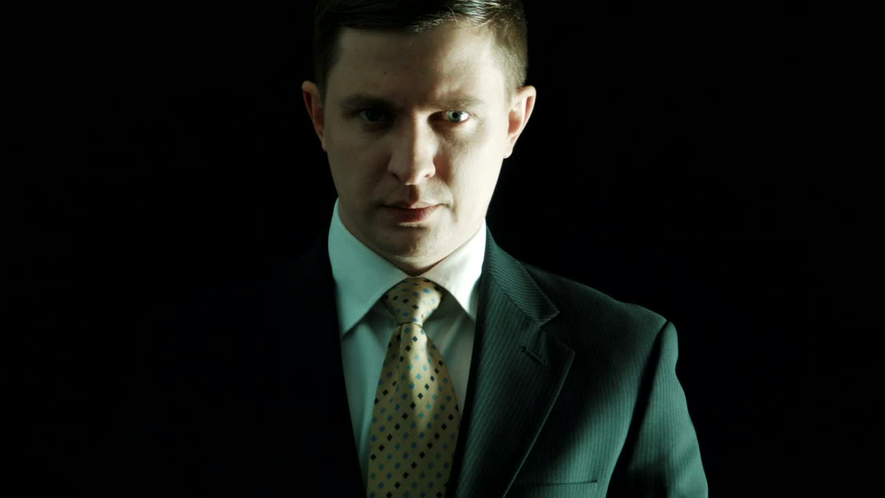 Stock Video Man In A Suit Putting Money On His Mouth Animated Wallpaper