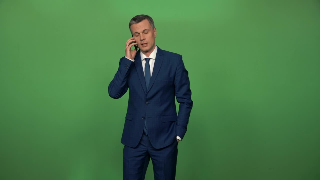 Stock Video Man In A Suit On A Phone Call In Front Animated Wallpaper