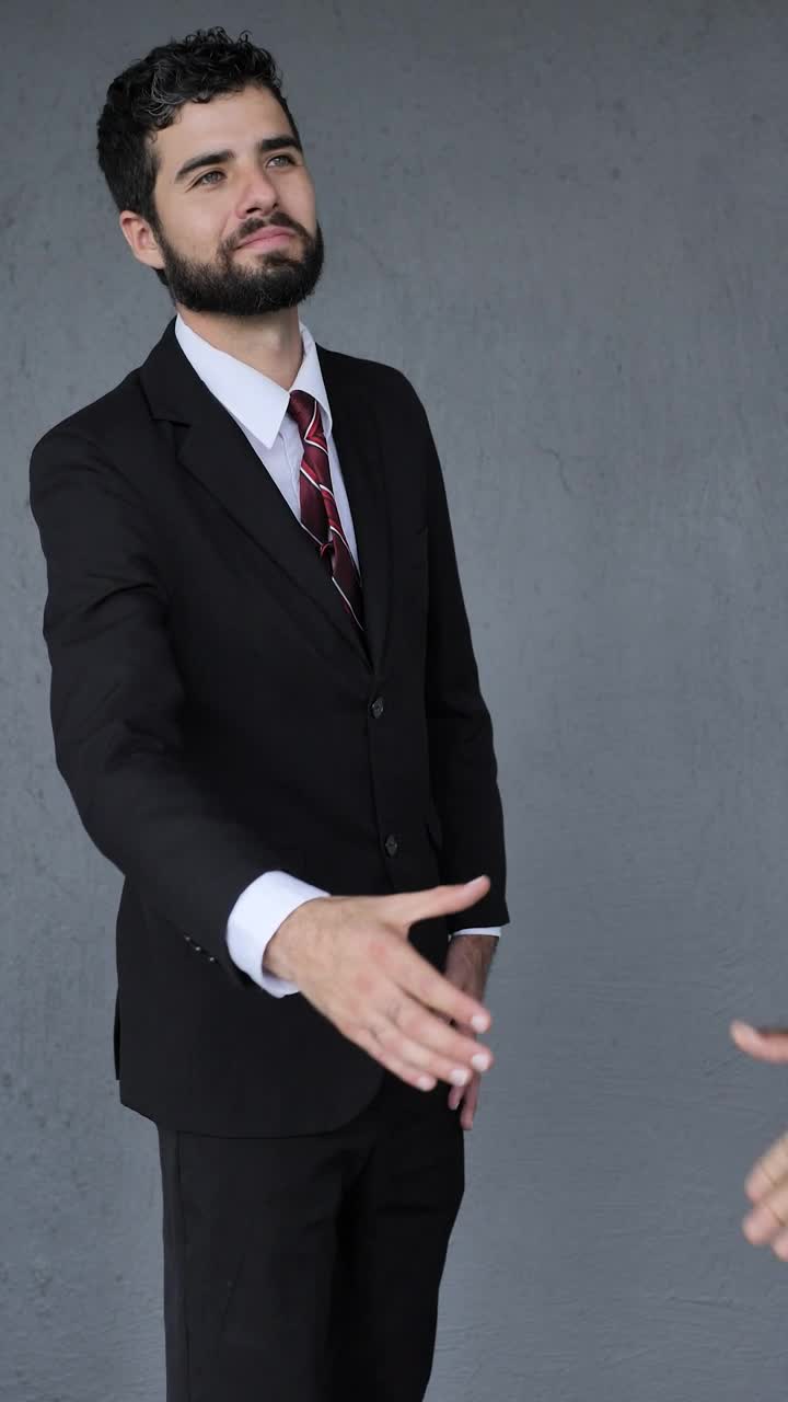 Stock Video Man In A Suit Giving A Firm Handshake Animated Wallpaper