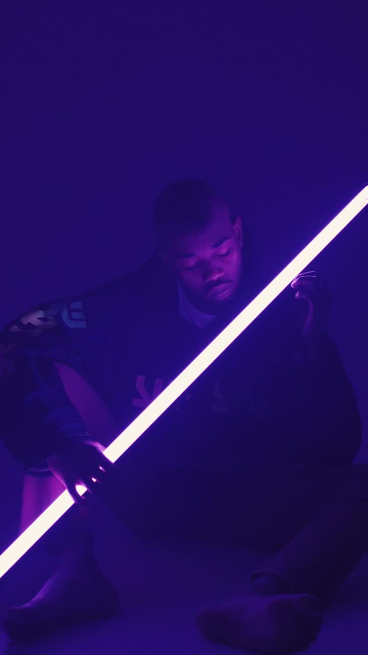 Stock Video Man Holding Neon Light Animated Wallpaper