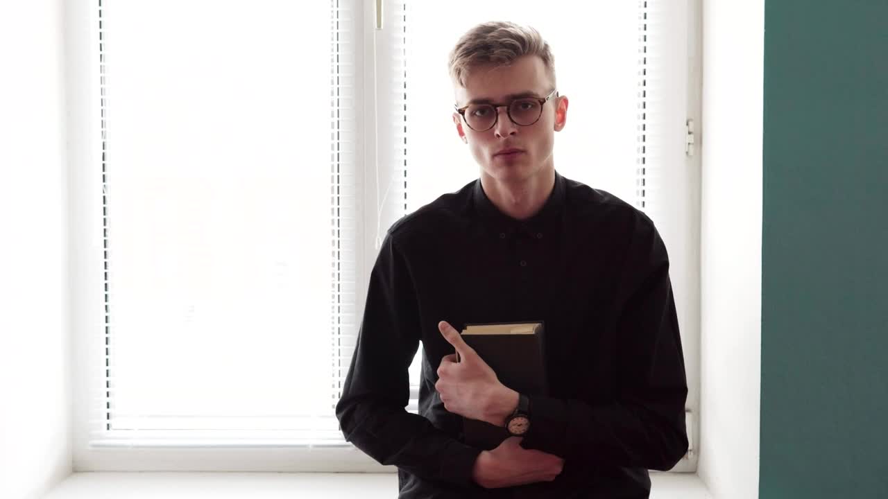 Stock Video Man Holding A Bible In Both Hands Animated Wallpaper