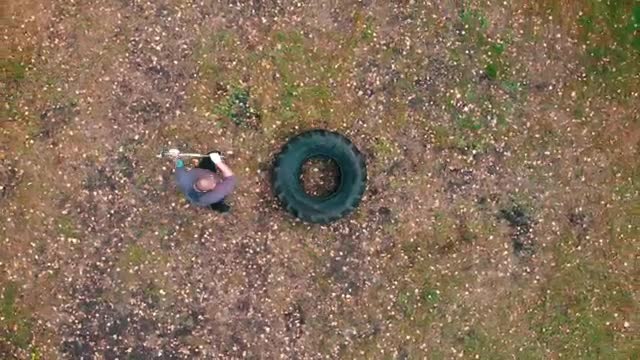 Stock Video Man Hitting A Large Truck Tire With A Mallet Smal Animated Wallpaper