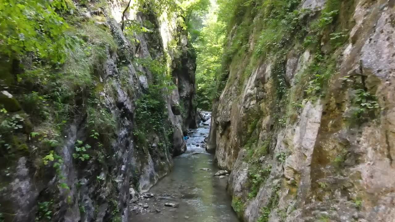 Stock Video Man Hiking In A Canyon With A Stream Animated Wallpaper
