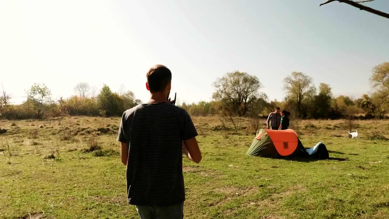 Stock Video Man Helps Friends Start Fire On Camping Trip Animated Wallpaper