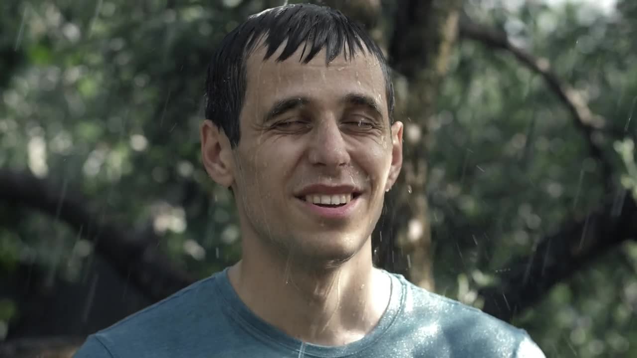 Stock Video Man Happily Getting Wet In The Rain Animated Wallpaper