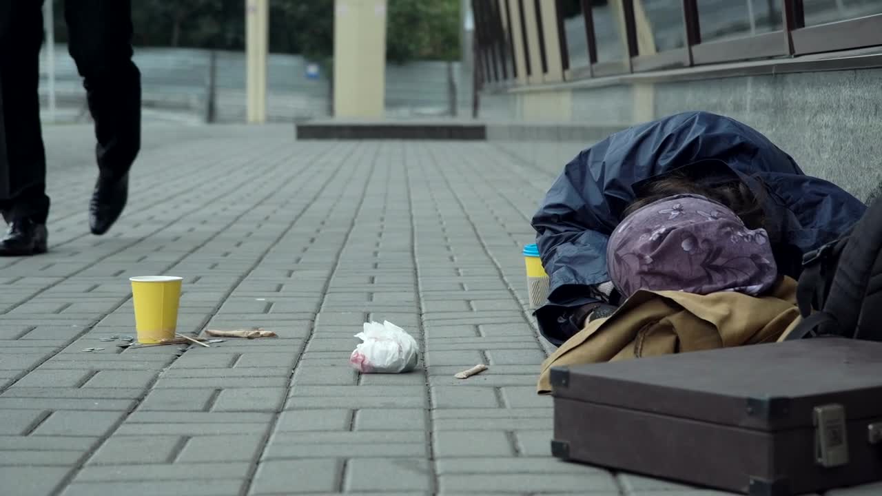 Stock Video Man Giving Money To Homeless Resting On The Street Animated Wallpaper