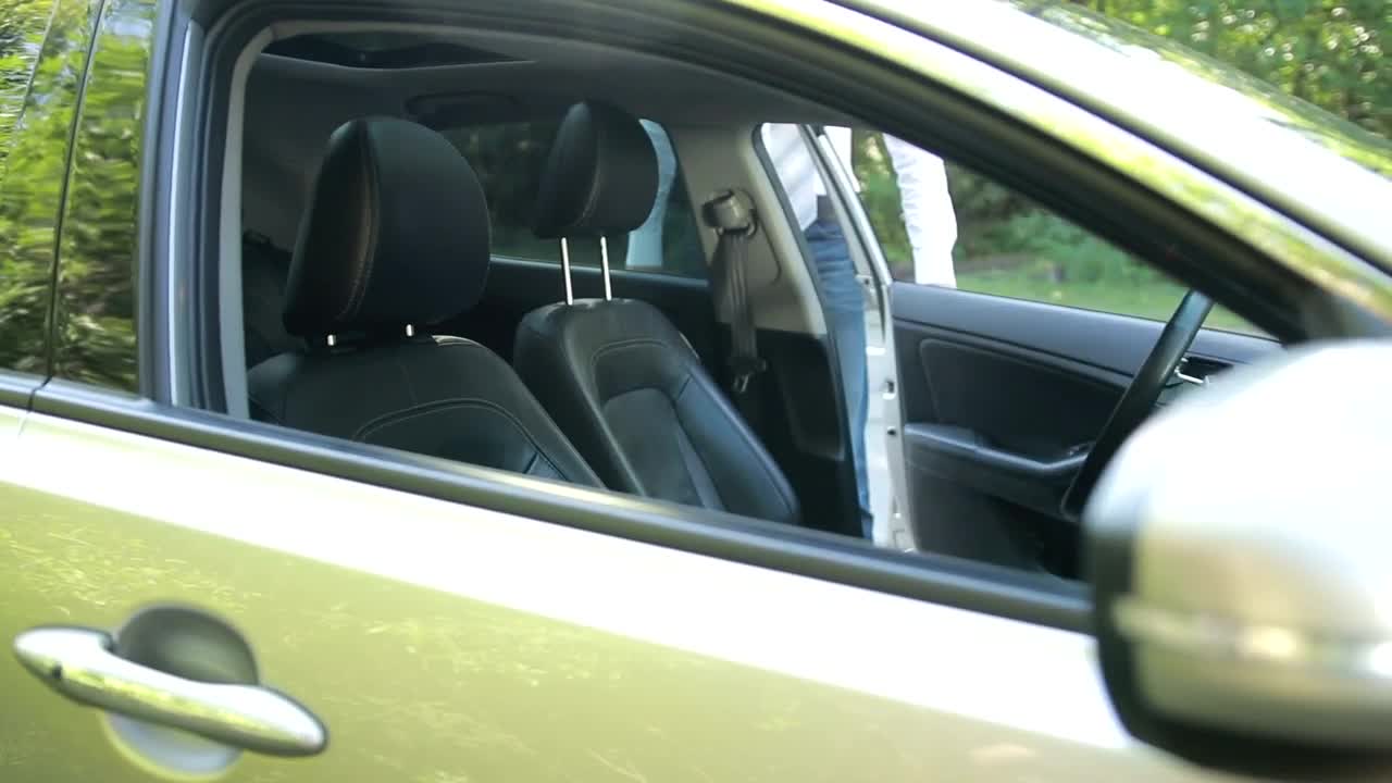 Stock Video Man Getting Into A Car And Putting On A Seat Animated Wallpaper