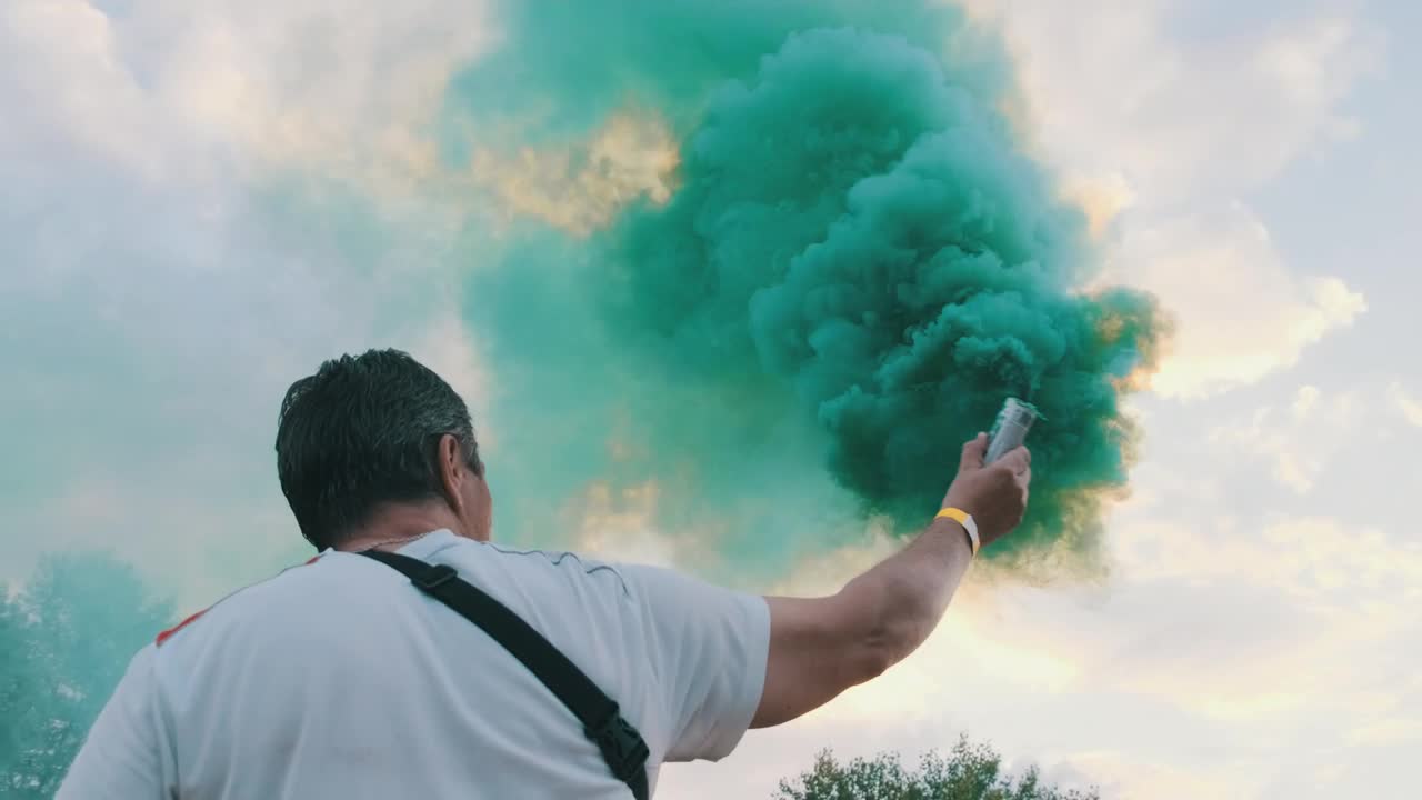 Stock Video Man From Behind Waving A Smoke Bomb Animated Wallpaper