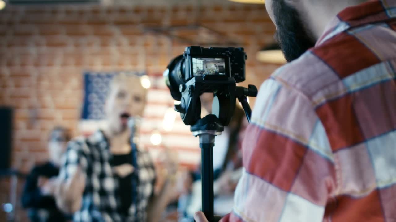 Stock Video Man Filming A Musical Band Animated Wallpaper