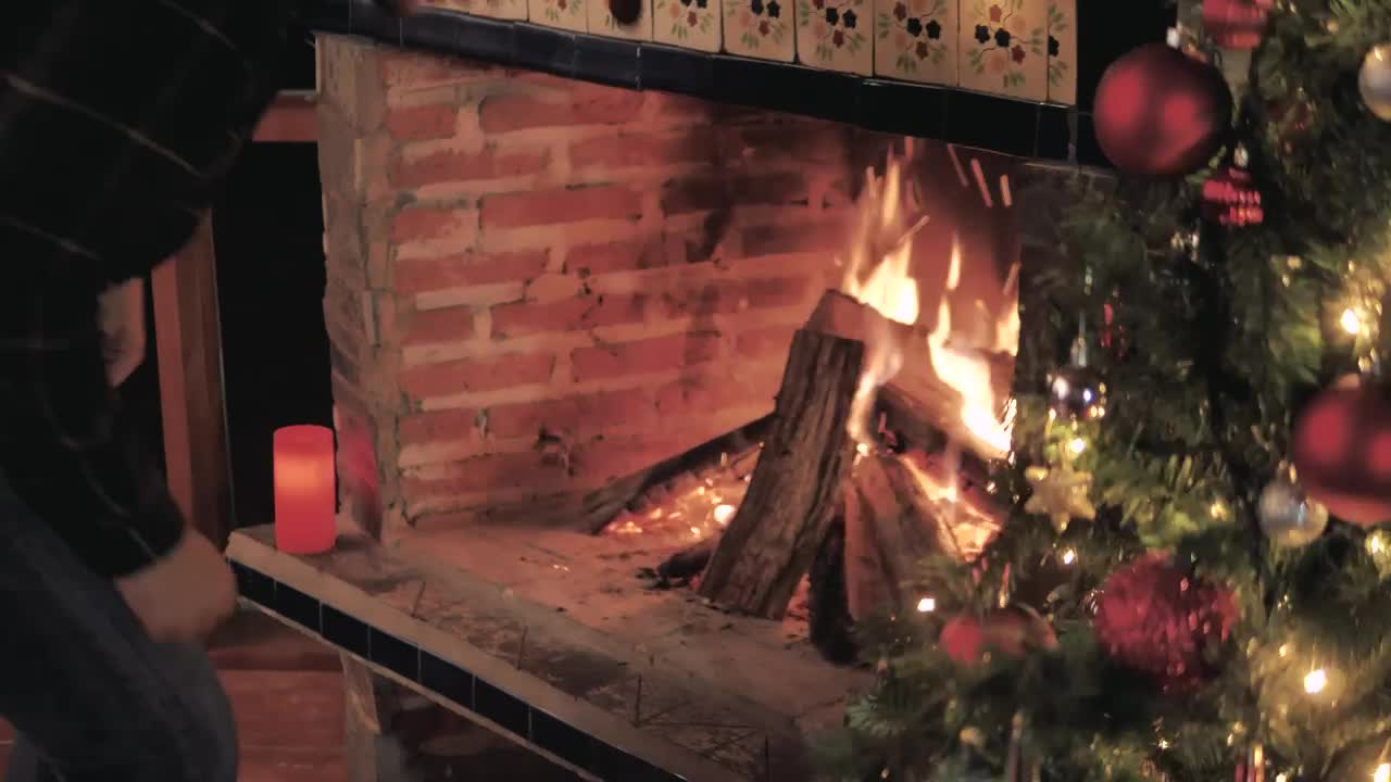 Stock Video Man Feeds The Fire From His Fireplace Animated Wallpaper