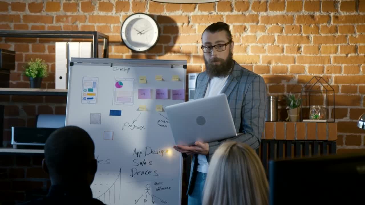 Stock Video Man Explaining Charts To A Small Audience Animated Wallpaper