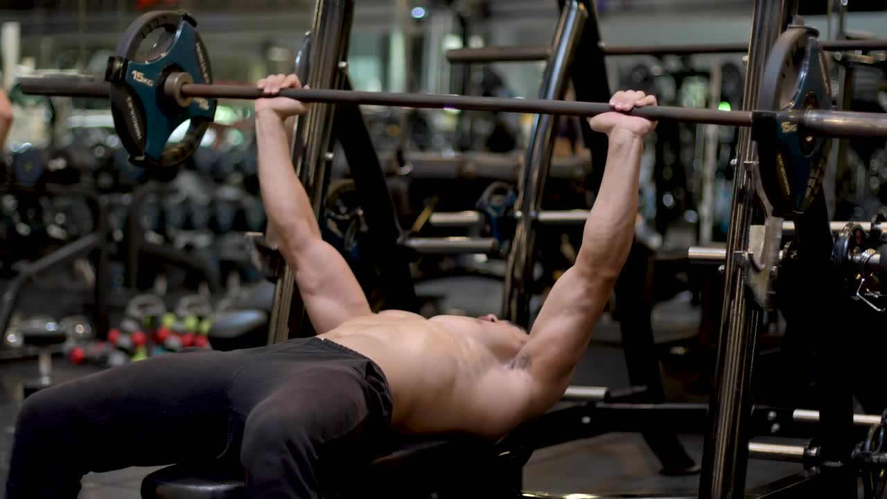 Stock Video Man Exercising With A Dumbbell In A Gym Animated Wallpaper