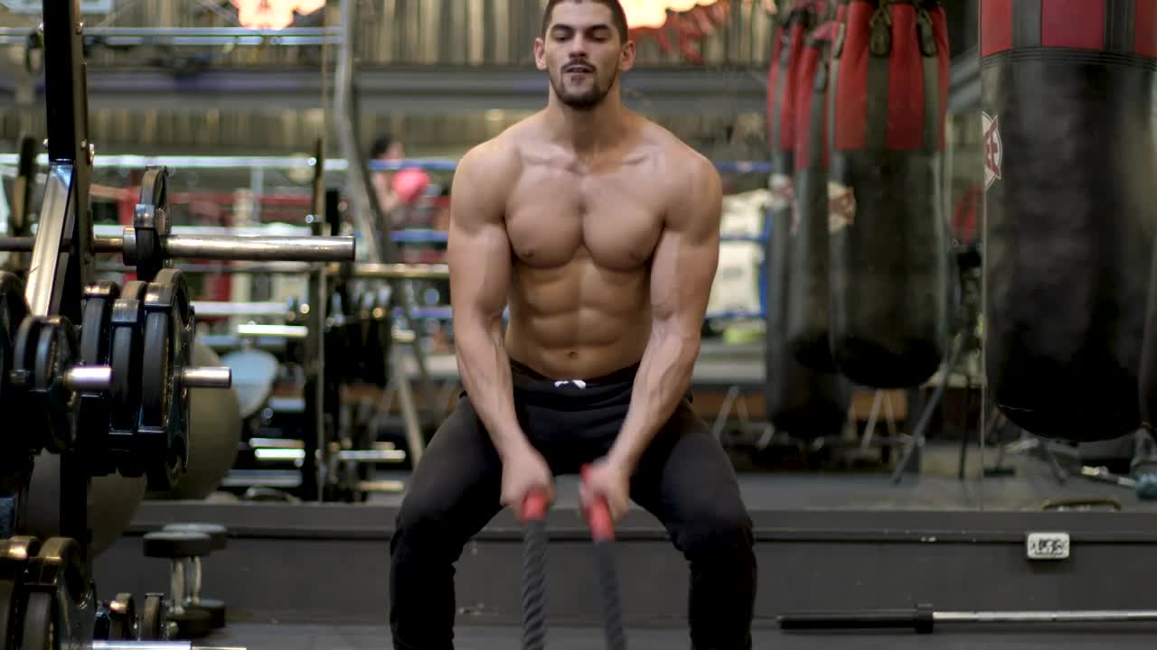 Stock Video Man Exercising Hard With A Pair Of Ropes Animated Wallpaper