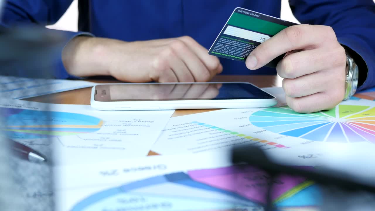 Stock Video Man Entering Credit Card Details On His Device Animated Wallpaper