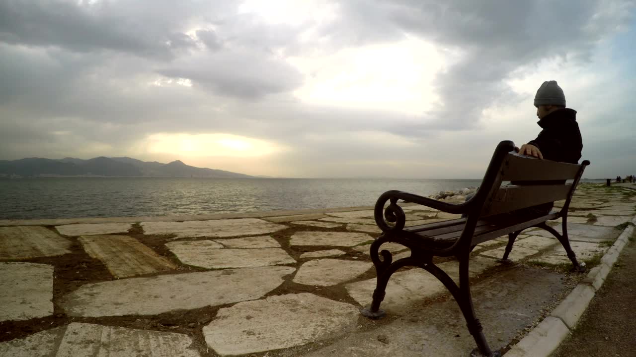 Stock Video Man Enjoying The Peace Of Seeing The Sea Animated Wallpaper