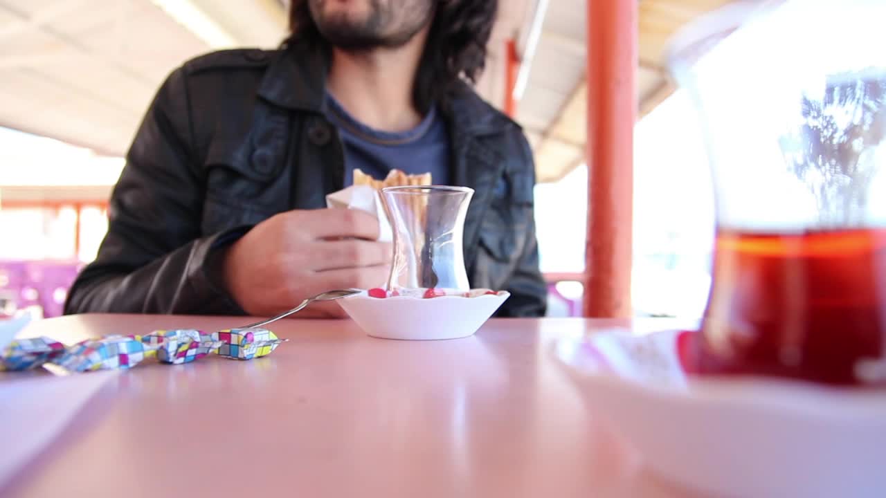 Stock Video Man Eating A Bread Sitting On A Dining Room Table Animated Wallpaper