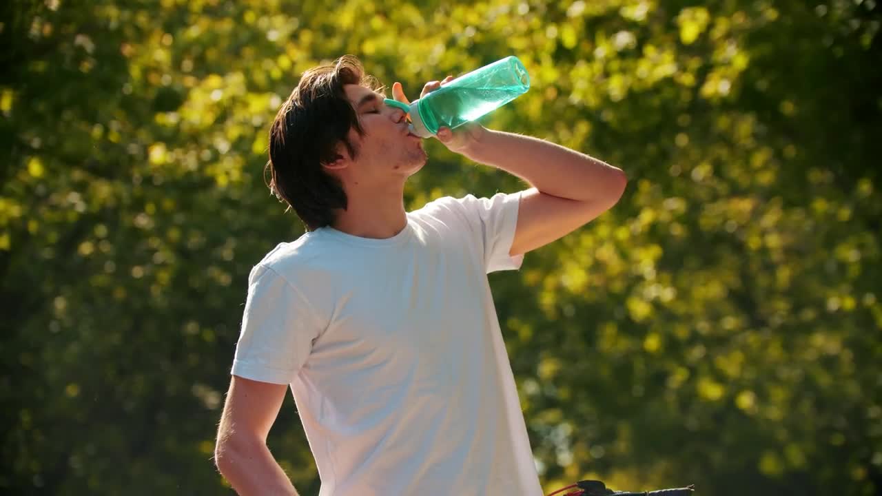 Stock Video Man Drinking Water From A Bottle And Riding His Bike Animated Wallpaper