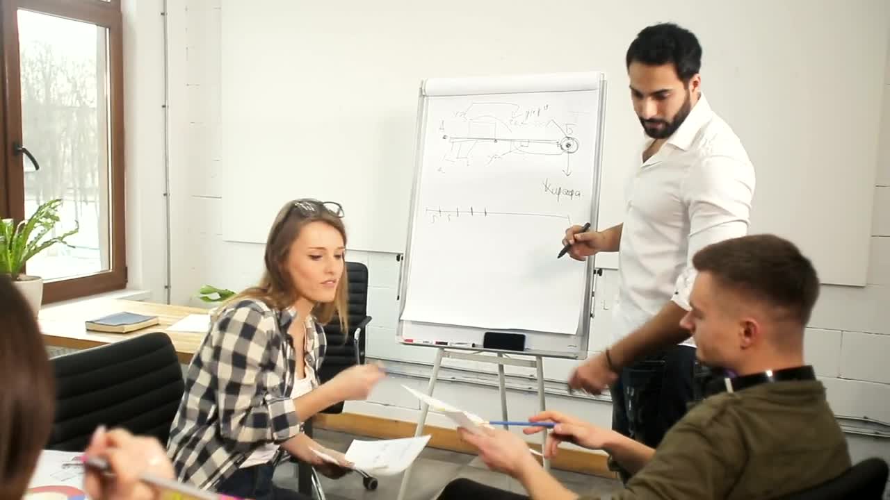 Stock Video Man Draws Strategy For Digital Marketing Team Animated Wallpaper