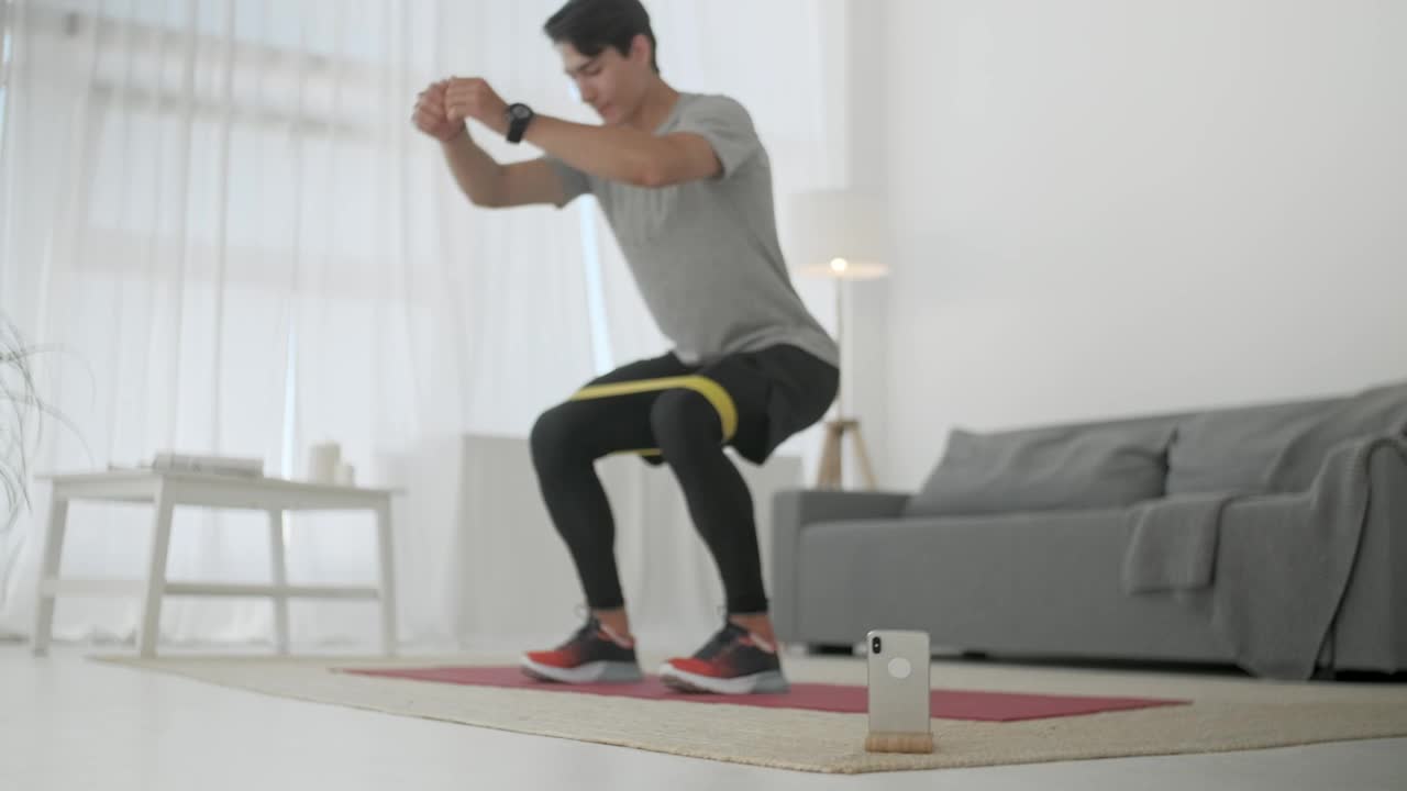 Stock Video Man Doing Squats At Home Animated Wallpaper