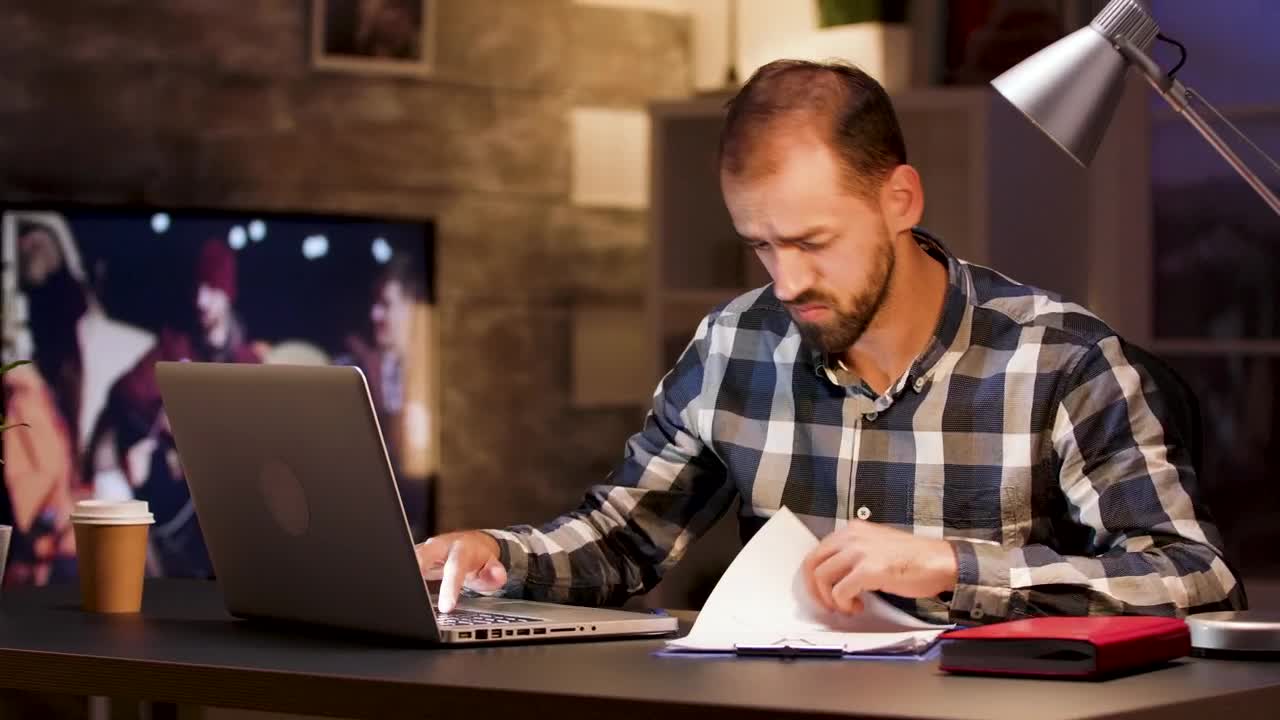 Stock Video Man Doing Research On Laptop From Home Office Animated Wallpaper