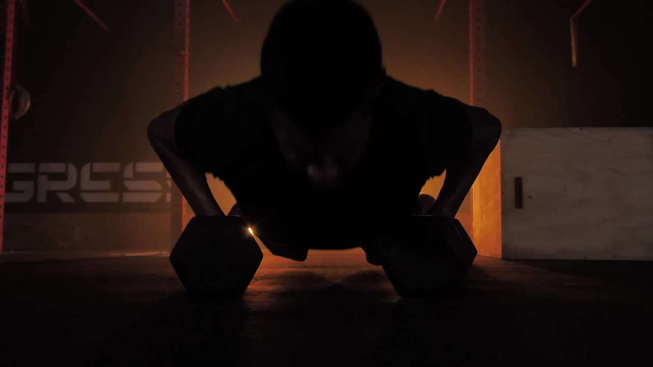 Stock Video Man Doing Push Ups Using Dumbbells Animated Wallpaper
