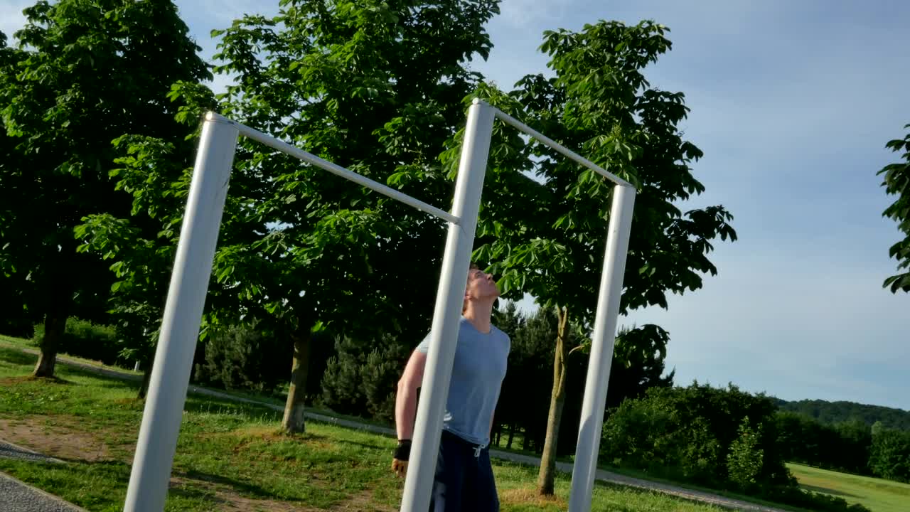 Stock Video Man Doing Pull Ups In The Park Animated Wallpaper