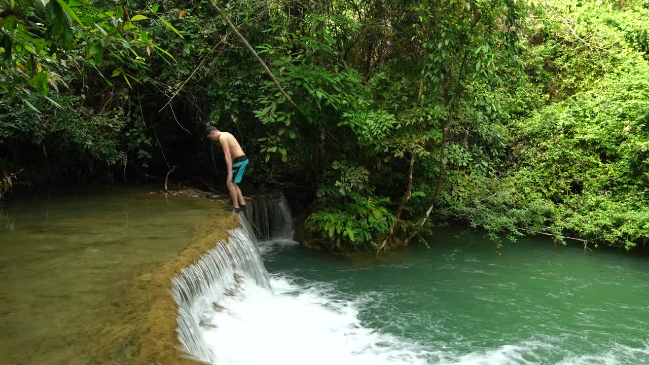 Stock Video Man Dives Into A Small Waterfall Animated Wallpaper