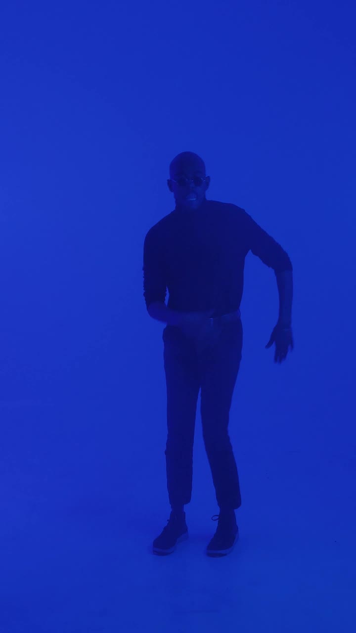 Stock Video Man Dancing Under Changing Lights Animated Wallpaper