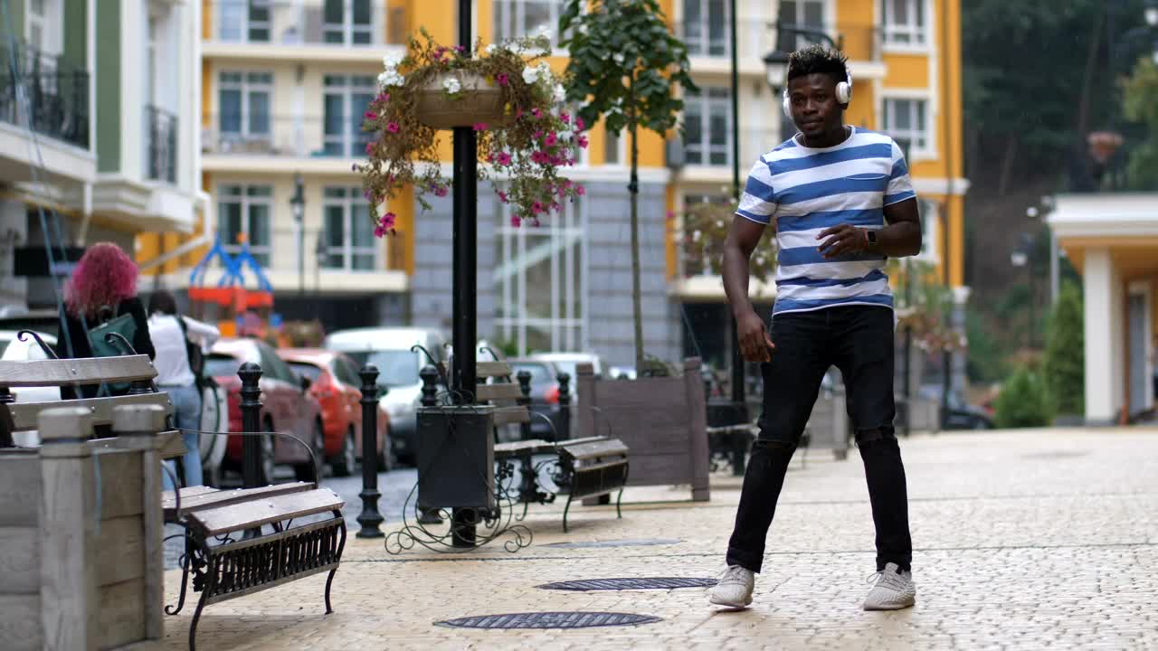 Stock Video Man Dancing In The Street With Headphones Animated Wallpaper