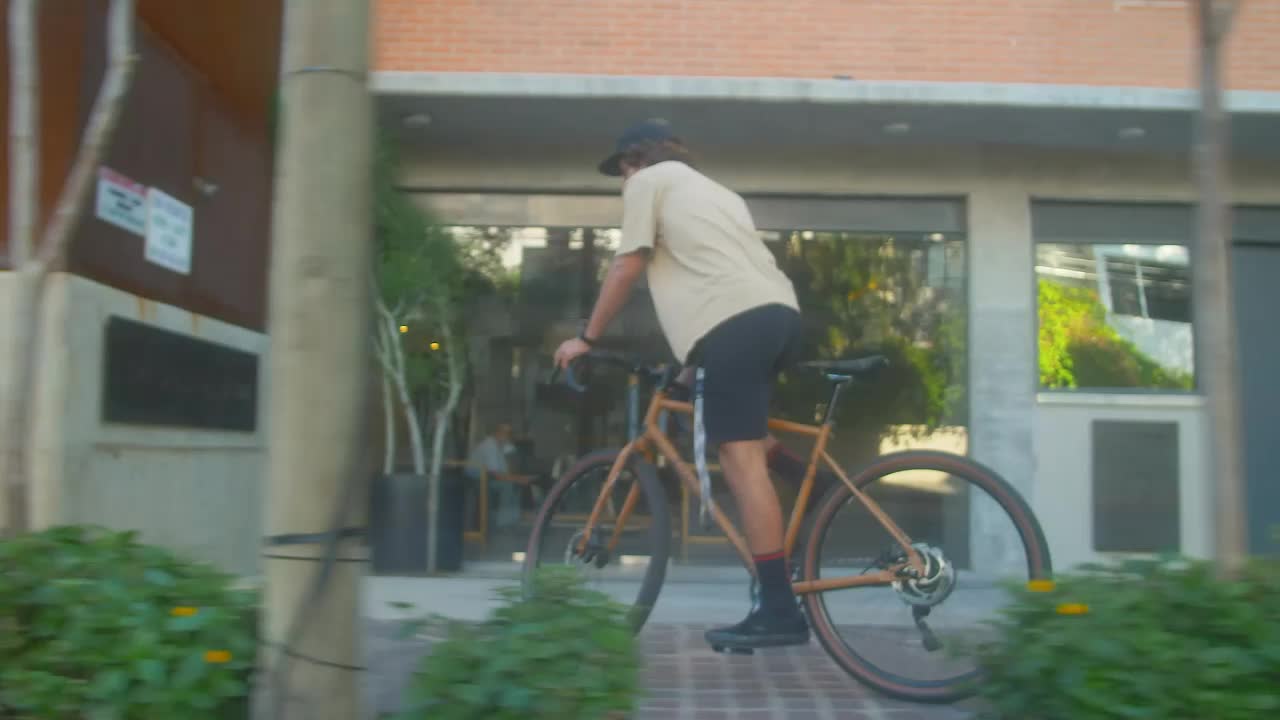 Stock Video Man Cycling Down A Street In A City Animated Wallpaper