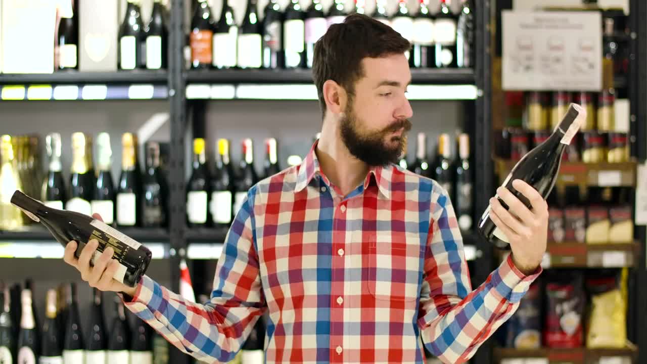 Stock Video Man Confused Over Which Wine To Buy Animated Wallpaper