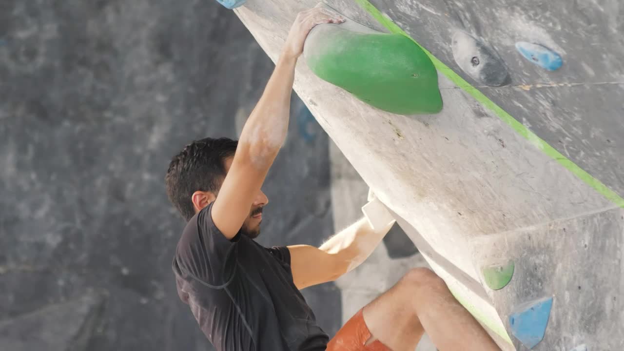 Stock Video Man Climbing Up A Sloping Mountaineering Wall Animated Wallpaper