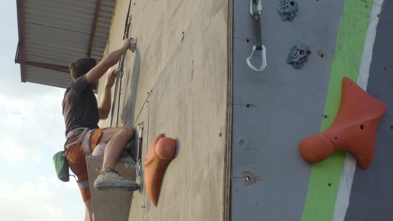 Stock Video Man Climbing On Top Of A Mountaineering Tower Animated Wallpaper