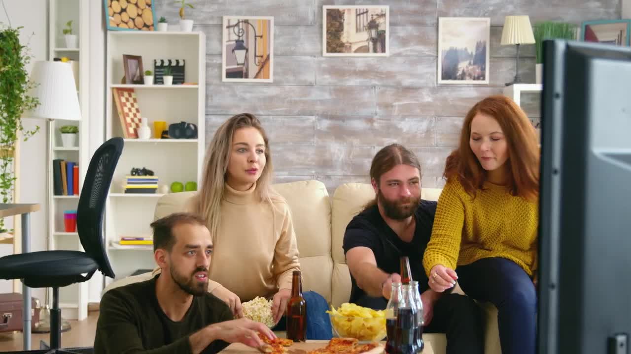 Stock Video Man Clapping While Watching Tv With Friends Animated Wallpaper